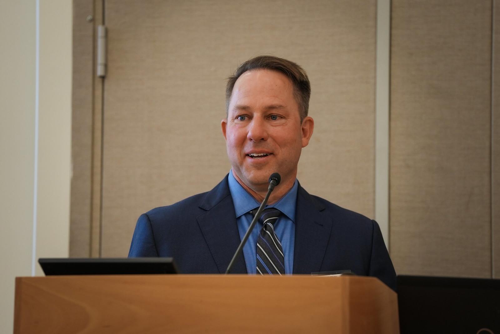 Andy Gere at a podium
