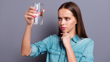 girl looking at a glass of water