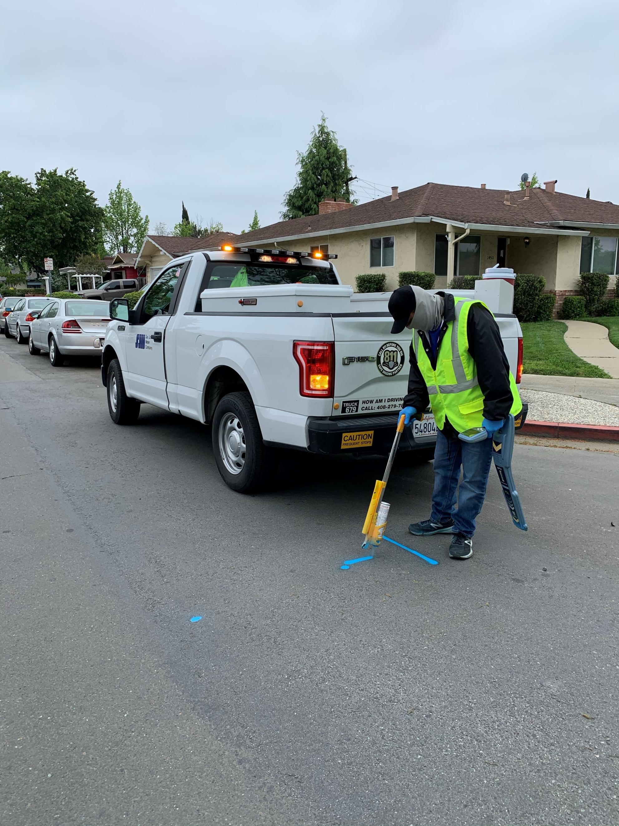 San Jose Water employee marking the street with spray paint
