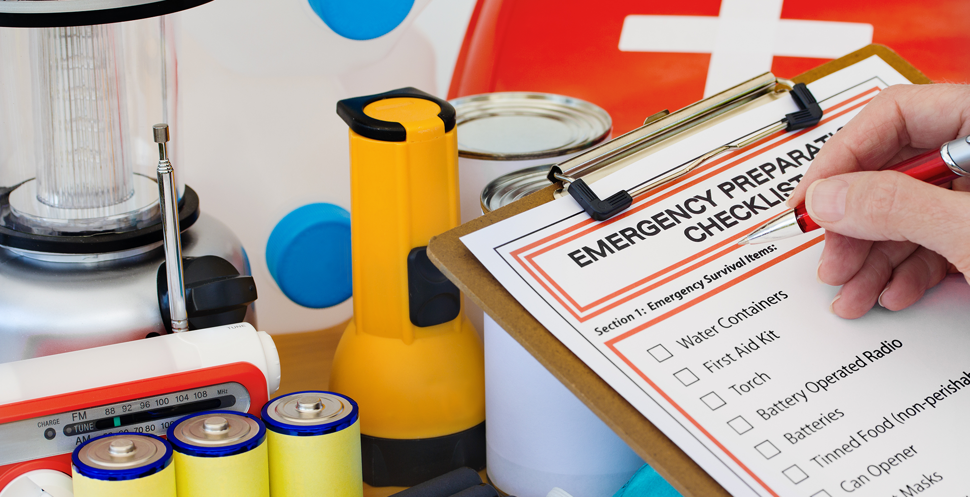 an image of a emergency preparation checklist with supplies in the background