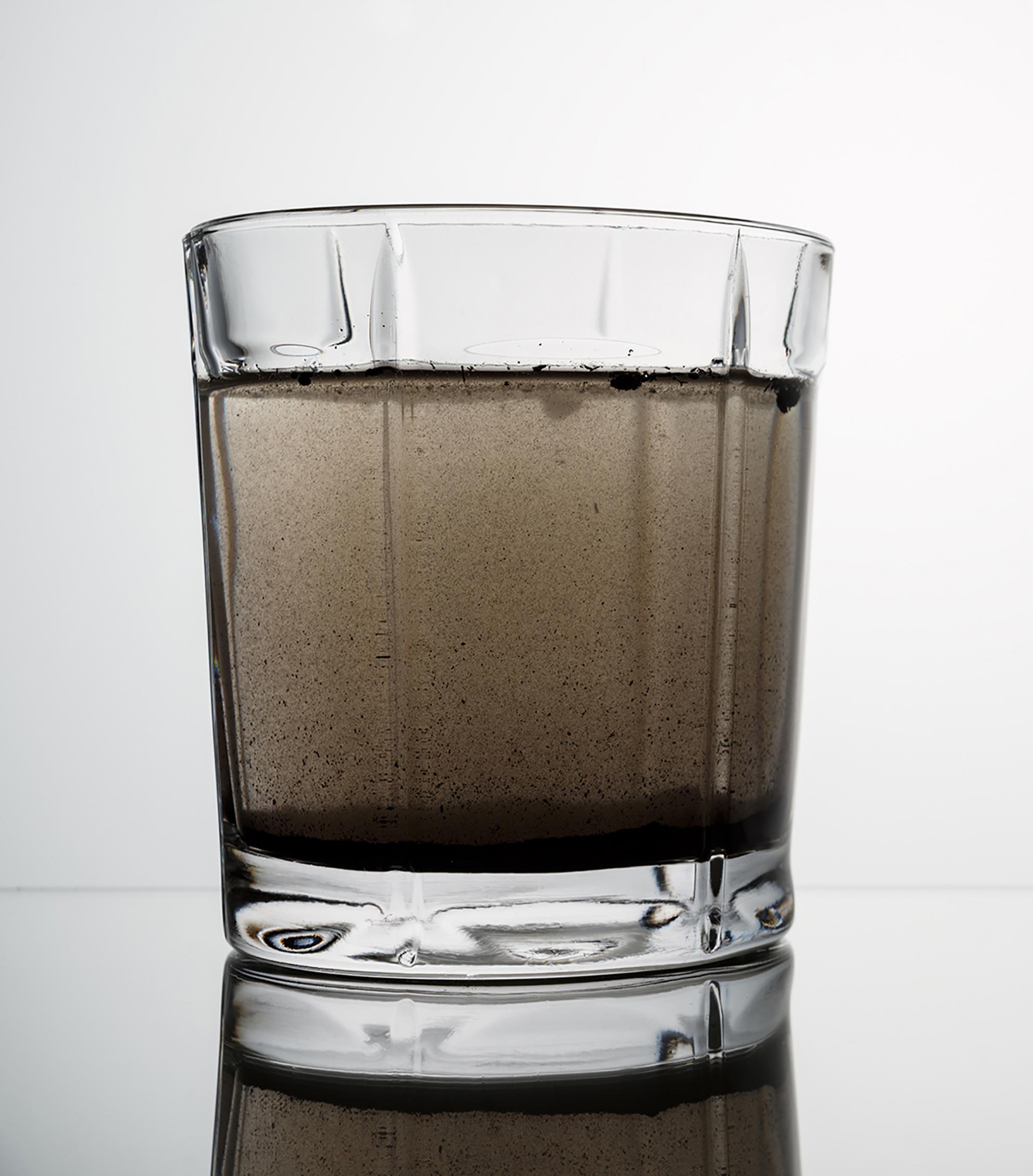 glass of black or gray water